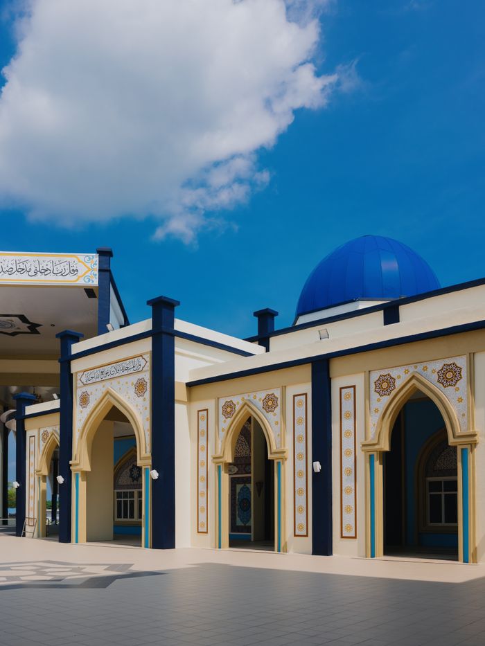 Stunning Islamic architecture of a mosque in Malaysia featuring ornate designs and a blue dome.